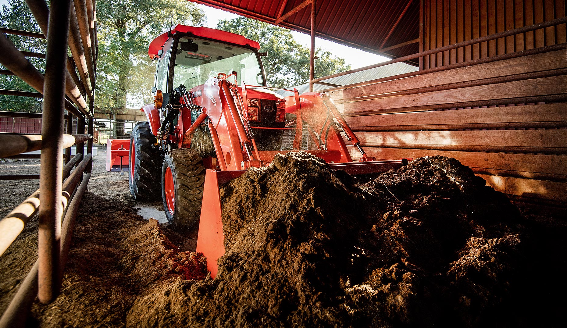 Tractor Scooping Manure in Barn